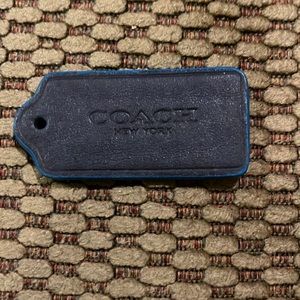 BLACK LEATHER COACH TAG WITH AQUA BLUE RUBBERIZED BORDER